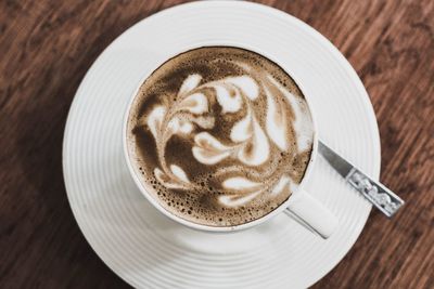 Close-up of cappuccino served on table