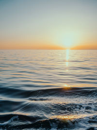 Scenic view of sea against clear sky during sunset