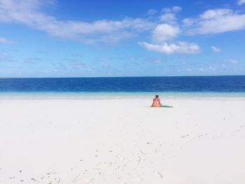 Woman on beach against sky