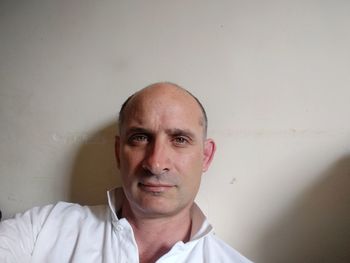 Portrait of mature man against wall