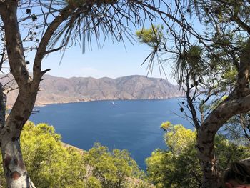 Scenic view of sea and mountains against sky