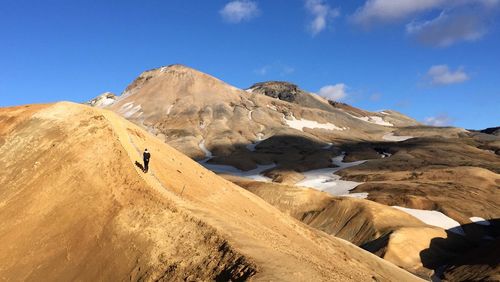 Person walking on mountain slope