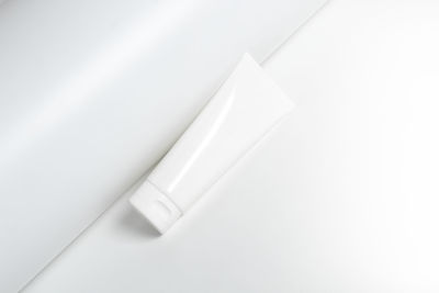 Close-up of cosmetic tube against white background