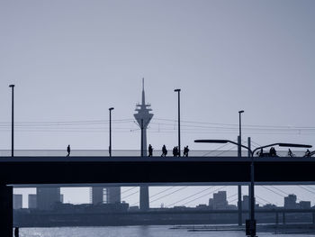 Bridge over city against clear sky