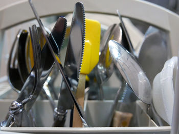 Close-up of washed utensils in dish rack