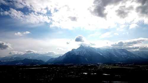 Scenic view of mountains against cloudy sky