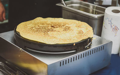 Close-up of pancake cooking on stove at kitchen