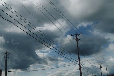 Low angle view of electricity pylon against sky