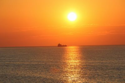 Scenic view of sea against orange sky