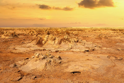 Scenic view of land against sky during sunset