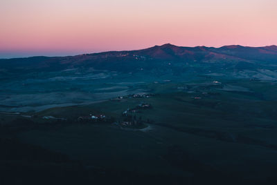 Scenic view of silhouette mountains against sky at sunset