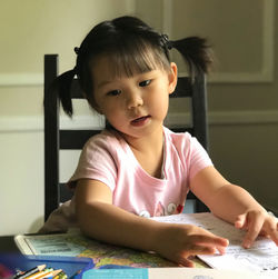 Portrait of cute girl at table