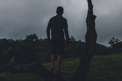 Silhouette man standing on field