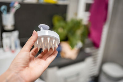 Cropped hand of woman drinking glass