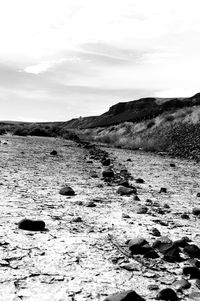 Scenic view of rocks on field against sky