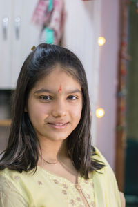 Portrait of young woman at home