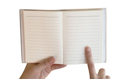 Hand holding book against white background