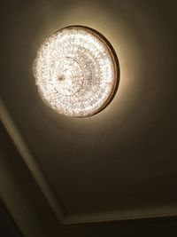 Directly below shot of illuminated pendant light hanging from ceiling