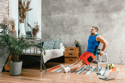 Full length of young man on table