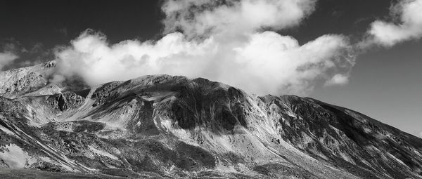 Low angle view of volcanic mountain against sky