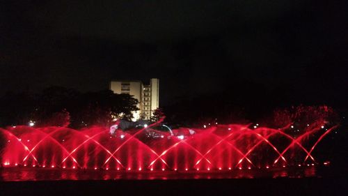 Illuminated fireworks against sky at night