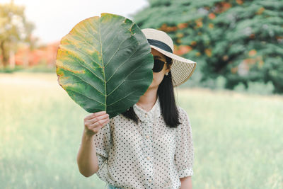 Midsection of woman holding umbrella