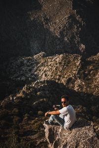 Full length of young man standing on cliff