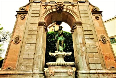 Low angle view of statue against historic building