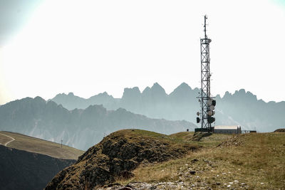 Windmill on mountain against sky