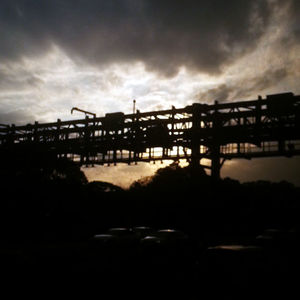 Silhouette of built structure against cloudy sky