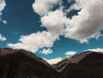 Low angle view of mountain against cloudy sky