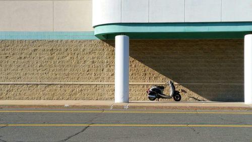 Motorcycle on footpath against building