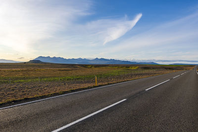 Scenic view of road by landscape against sky