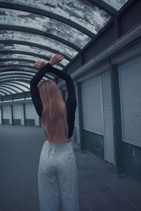 Rear view of woman standing in building