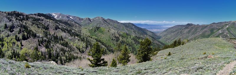 Scenic view of mountains against blue sky