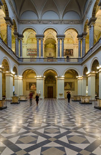 People walking in illuminated building