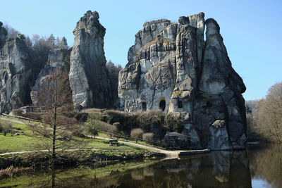 Panoramic view of trees and rocks against sky