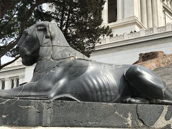 Statue against historic building