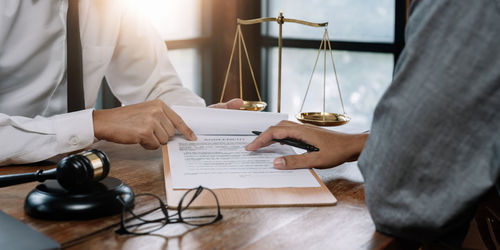 Midsection of lawyer working at table