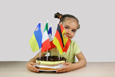 Portrait of woman holding gift against white background