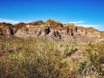 Low angle view of rock formations against blue sky