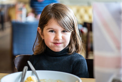 Portrait of cute girl in restaurant