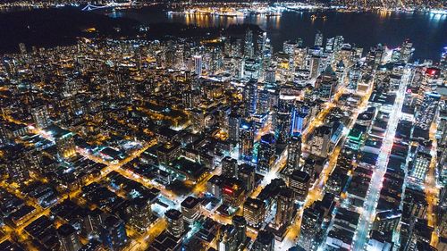 High angle view of city lit up at night