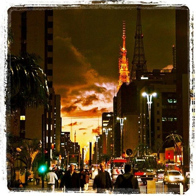 building exterior, architecture, built structure, transfer print, sky, city, tower, tall - high, illuminated, low angle view, auto post production filter, travel destinations, travel, sunset, famous place, cloud - sky, tourism, city life, outdoors, street light