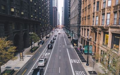 High angle view of cars on road amidst buildings in city