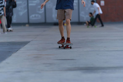 Low section of people walking on street
