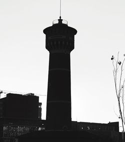 Low angle view of tower in city against clear sky