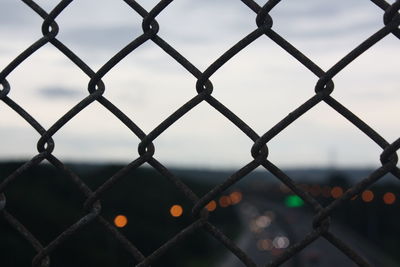 Full frame shot of chainlink fence against sky