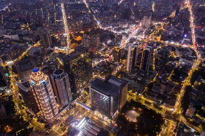 High angle view of city lit up at night