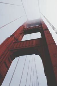 Low angle view of suspension bridge against clear sky